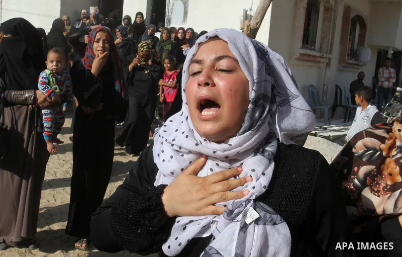 Relatives of Amir Jaber Abu Taimeh, a member of the Ezzedine al-Qassam Brigades, the military wing of the Palestinian Islamist movement Hamas, mourn during his funeral in Khan Yunis in the southern Gaza Strip on October...