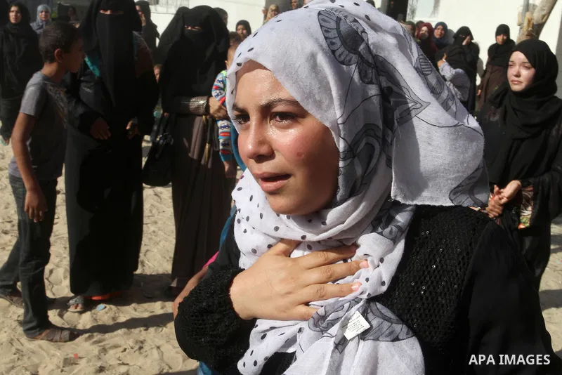 Relatives of Amir Jaber Abu Taimeh, a member of the Ezzedine al-Qassam Brigades, the military wing of the Palestinian Islamist movement Hamas, mourn during his funeral in Khan Yunis in the southern Gaza Strip on October...