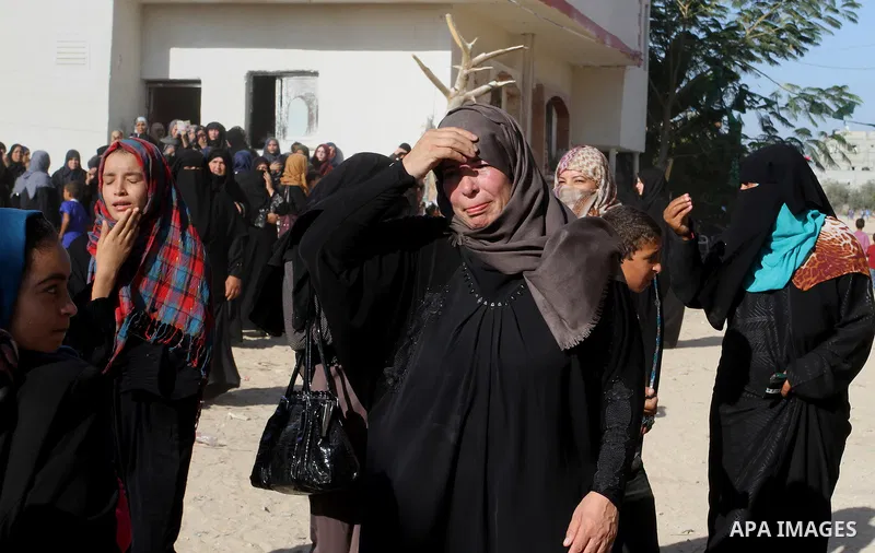 Relatives of Amir Jaber Abu Taimeh, a member of the Ezzedine al-Qassam Brigades, the military wing of the Palestinian Islamist movement Hamas, mourn during his funeral in Khan Yunis in the southern Gaza Strip on October...