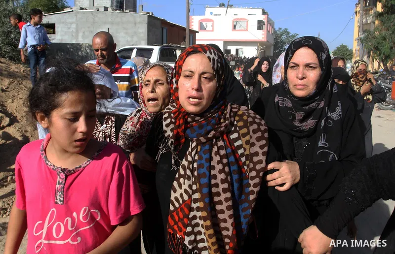 Relatives of Amir Jaber Abu Taimeh, a member of the Ezzedine al-Qassam Brigades, the military wing of the Palestinian Islamist movement Hamas, mourn during his funeral in Khan Yunis in the southern Gaza Strip on October...