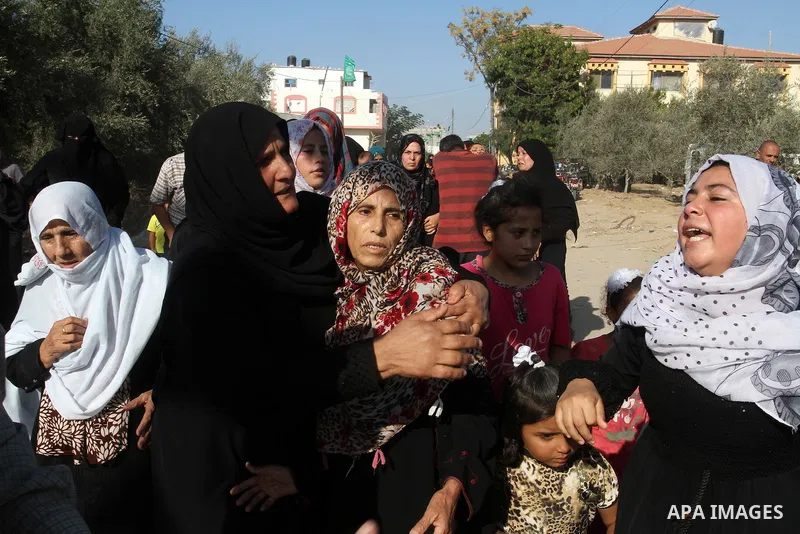 Relatives of Amir Jaber Abu Taimeh, a member of the Ezzedine al-Qassam Brigades, the military wing of the Palestinian Islamist movement Hamas, mourn during his funeral in Khan Yunis in the southern Gaza Strip on October...
