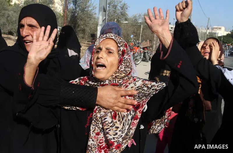 Relatives of Amir Jaber Abu Taimeh, a member of the Ezzedine al-Qassam Brigades, the military wing of the Palestinian Islamist movement Hamas, mourn during his funeral in Khan Yunis in the southern Gaza Strip on October...