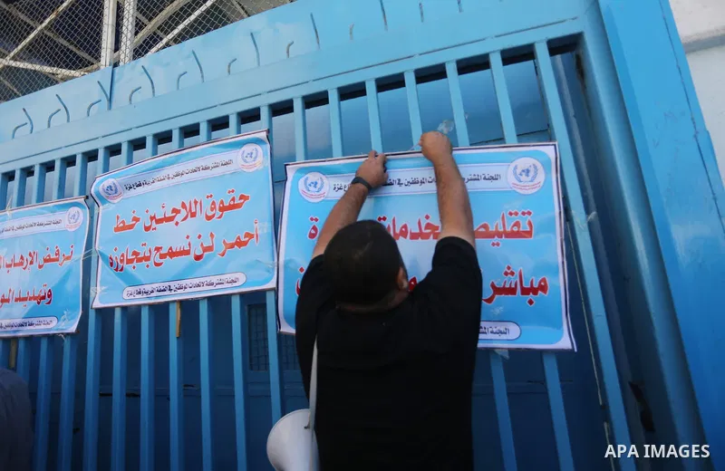 Palestinians hold banners during a protest against the UNRWA decision to reduce of the aid in front of the headquarters United Nations Relief and Works Agency (UNRWA), in Gaza city, on October 25, 2016. Photo by Mohammed...