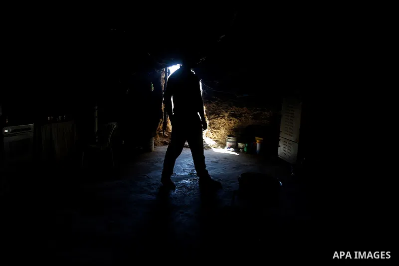 A Palestinian man of Hawamdeh family walks inside a cave he lives in, in West Bank village of Mufagara, south of Hebron on Oct. 25, 2016. Photo by Wisam Hashlamoun