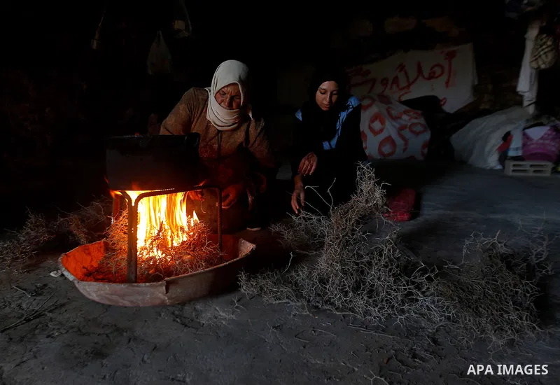 A Palestinian woman of Hawamdeh family cooks inside a cave she lives in, in West Bank village of Mufagara, south of Hebron on Oct. 25, 2016. Photo by Wisam Hashlamoun