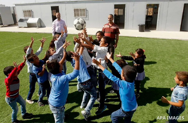 Palestinian students from Guwein primary mixed school play outside their classrooms in south of al-Samou village in the West Bank city of Hebron, on Oct. 25, 2016. Guwein school funded by the French goverment learn insid...