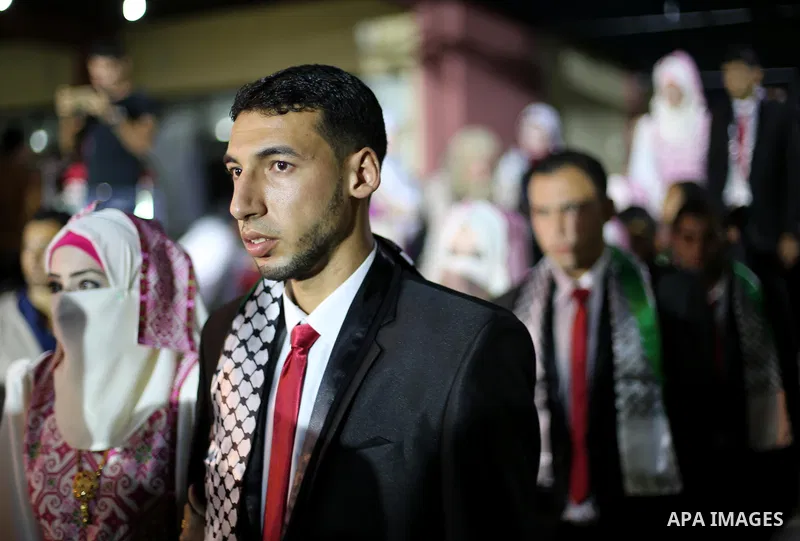 Palestinian grooms and brides take part in a mass wedding ceremony in Gaza city on Oct. 25, 2016. Nearly 20 Palestinian couples from War-wounded were married in a ceremony funded by the UAE government. Photo by Mohammed...