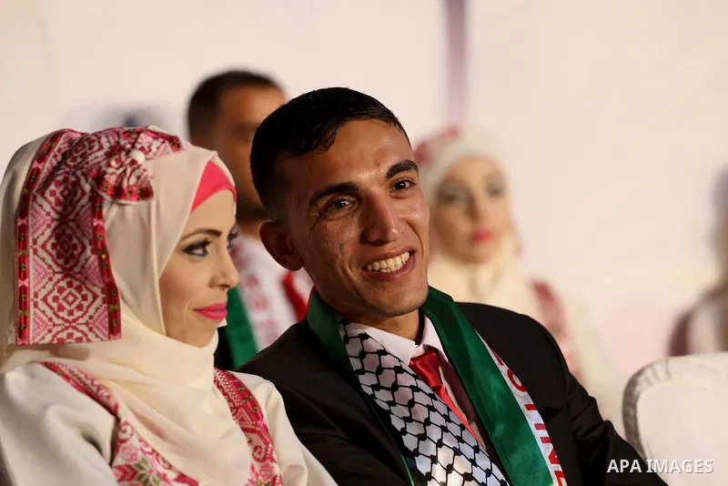 Palestinian grooms and brides take part in a mass wedding ceremony in Gaza city on Oct. 25, 2016. Nearly 20 Palestinian couples from War-wounded were married in a ceremony funded by the UAE government. Photo by Mohammed...