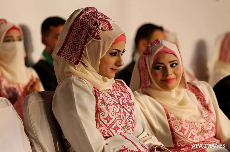 Palestinian grooms and brides take part in a mass wedding ceremony in Gaza city on Oct. 25, 2016. Nearly 20 Palestinian couples from War-wounded were married in a ceremony funded by the UAE government. Photo by Mohammed...