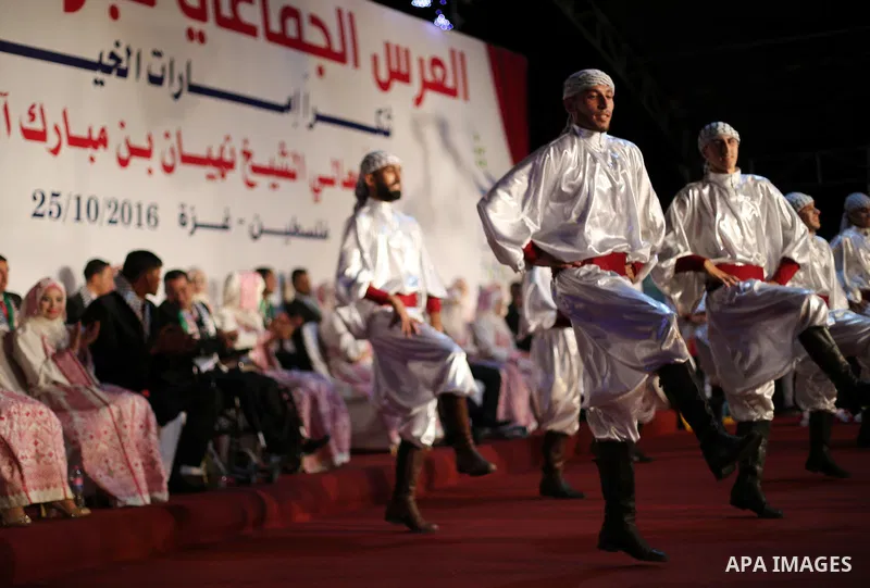 Members of Palestinian dance Dabka band perform during a mass wedding ceremony in Gaza city on Oct. 25, 2016. Nearly 20 Palestinian couples from War-wounded were married in a ceremony funded by the UAE government. Photo...