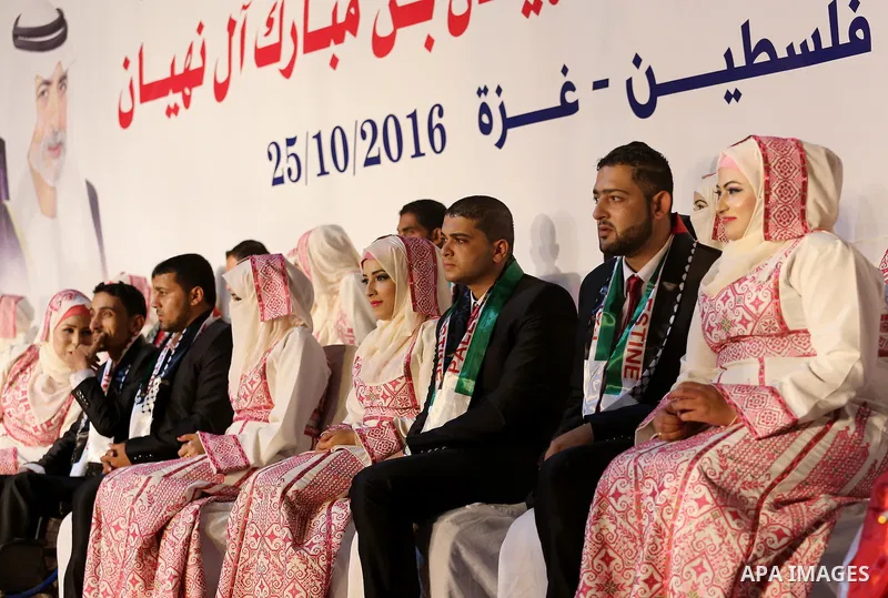 Palestinian grooms and brides take part in a mass wedding ceremony in Gaza city on Oct. 25, 2016. Nearly 20 Palestinian couples from War-wounded were married in a ceremony funded by the UAE government. Photo by Mohammed...