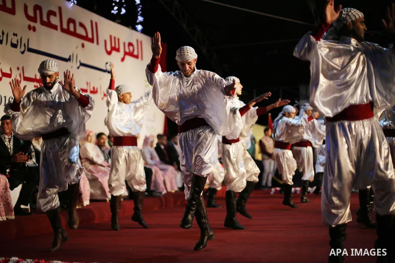 Members of Palestinian dance Dabka band perform during a mass wedding ceremony in Gaza city on Oct. 25, 2016. Nearly 20 Palestinian couples from War-wounded were married in a ceremony funded by the UAE government. Photo...