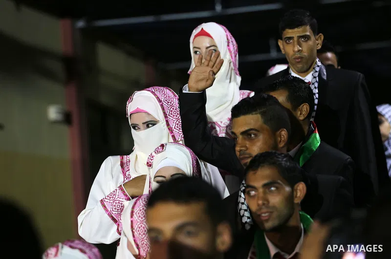 Palestinian grooms and brides take part in a mass wedding ceremony in Gaza city on Oct. 25, 2016. Nearly 20 Palestinian couples from War-wounded were married in a ceremony funded by the UAE government. Photo by Mohammed...