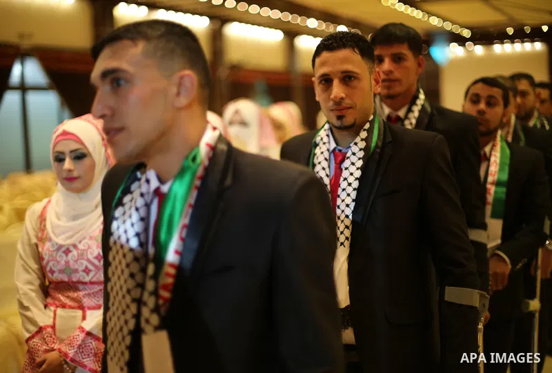 Palestinian grooms and brides take part in a mass wedding ceremony in Gaza city on Oct. 25, 2016. Nearly 20 Palestinian couples from War-wounded were married in a ceremony funded by the UAE government. Photo by Mohammed...