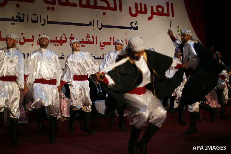 Members of Palestinian dance Dabka band perform during a mass wedding ceremony in Gaza city on Oct. 25, 2016. Nearly 20 Palestinian couples from War-wounded were married in a ceremony funded by the UAE government. Photo...