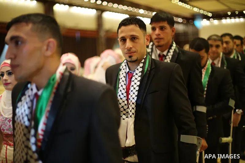 Palestinian grooms and brides take part in a mass wedding ceremony in Gaza city on Oct. 25, 2016. Nearly 20 Palestinian couples from War-wounded were married in a ceremony funded by the UAE government. Photo by Mohammed...