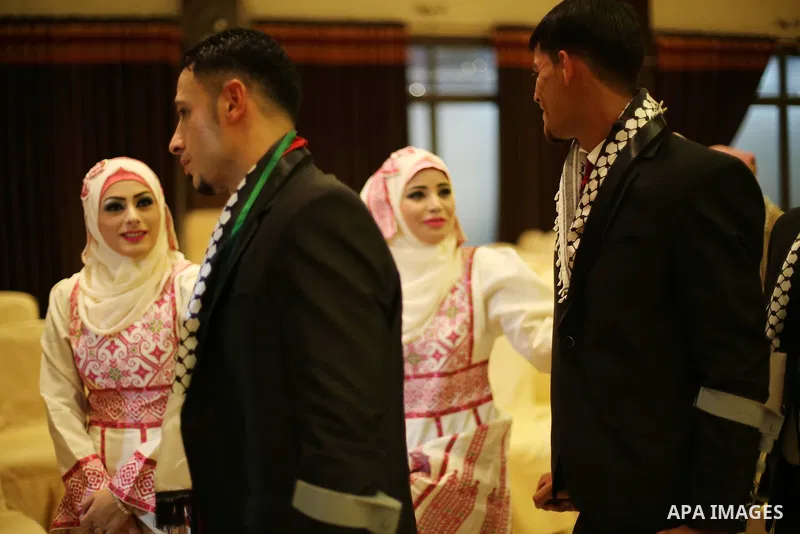 Palestinian grooms and brides take part in a mass wedding ceremony in Gaza city on Oct. 25, 2016. Nearly 20 Palestinian couples from War-wounded were married in a ceremony funded by the UAE government. Photo by Mohammed...