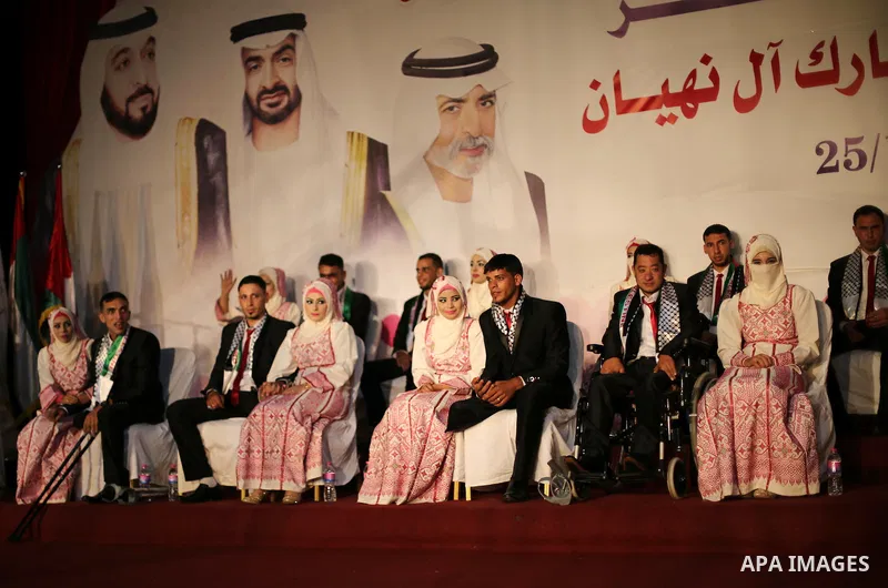 Palestinian grooms and brides take part in a mass wedding ceremony in Gaza city on Oct. 25, 2016. Nearly 20 Palestinian couples from War-wounded were married in a ceremony funded by the UAE government. Photo by Mohammed...