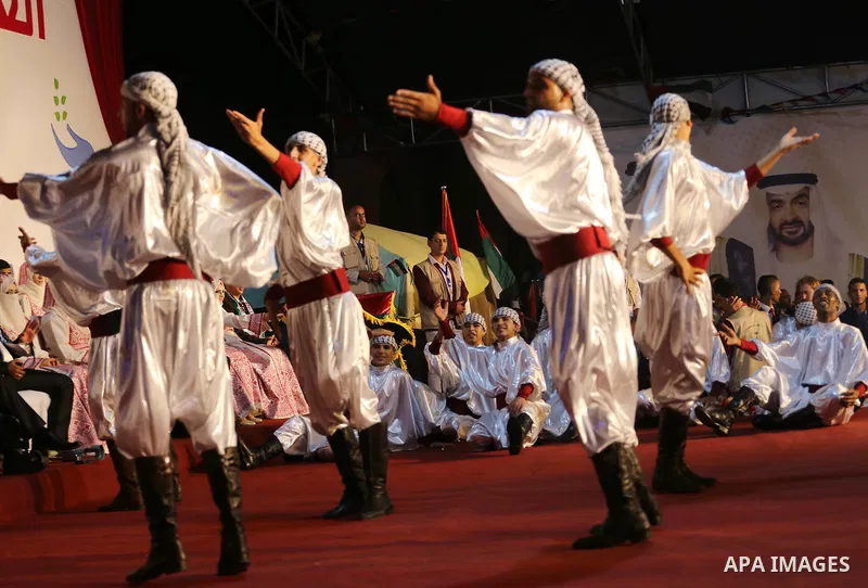 Members of Palestinian dance Dabka band perform during a mass wedding ceremony in Gaza city on Oct. 25, 2016. Nearly 20 Palestinian couples from War-wounded were married in a ceremony funded by the UAE government. Photo...
