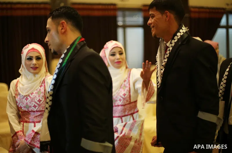 Palestinian grooms and brides take part in a mass wedding ceremony in Gaza city on Oct. 25, 2016. Nearly 20 Palestinian couples from War-wounded were married in a ceremony funded by the UAE government. Photo by Mohammed...