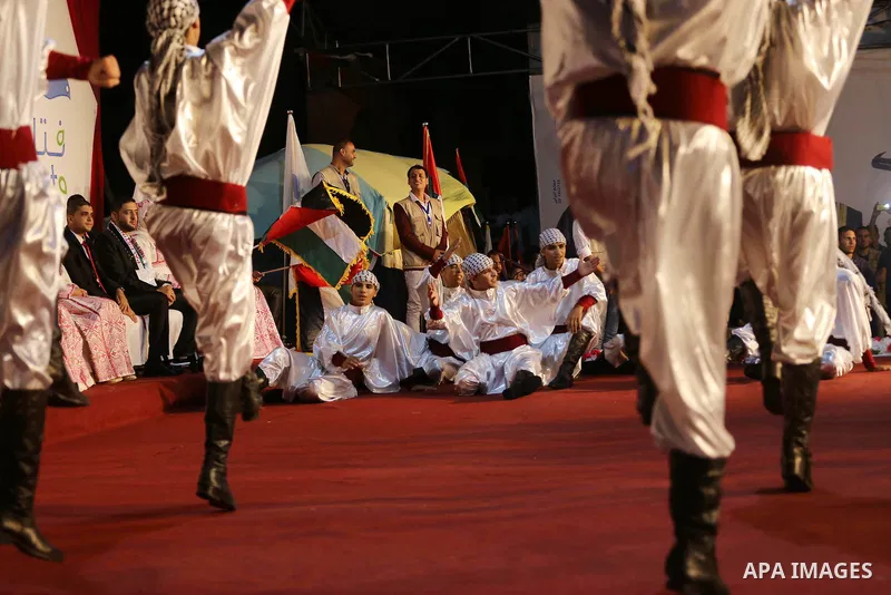 Members of Palestinian dance Dabka band perform during a mass wedding ceremony in Gaza city on Oct. 25, 2016. Nearly 20 Palestinian couples from War-wounded were married in a ceremony funded by the UAE government. Photo...