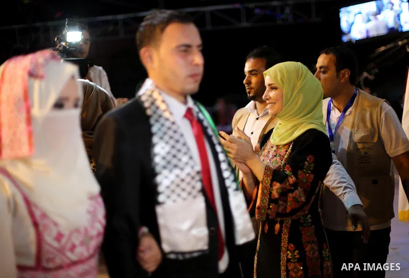 Ms. Jalila Dahlan attends a mass wedding ceremony in Gaza city on Oct. 25, 2016. Nearly 20 Palestinian couples from War-wounded were married in a ceremony funded by the UAE government. Photo by Mohammed Asad