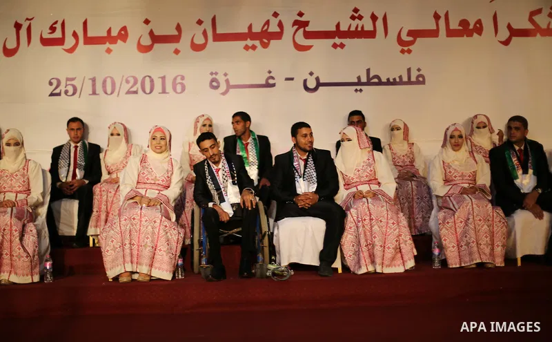 Palestinian grooms and brides take part in a mass wedding ceremony in Gaza city on Oct. 25, 2016. Nearly 20 Palestinian couples from War-wounded were married in a ceremony funded by the UAE government. Photo by Mohammed...