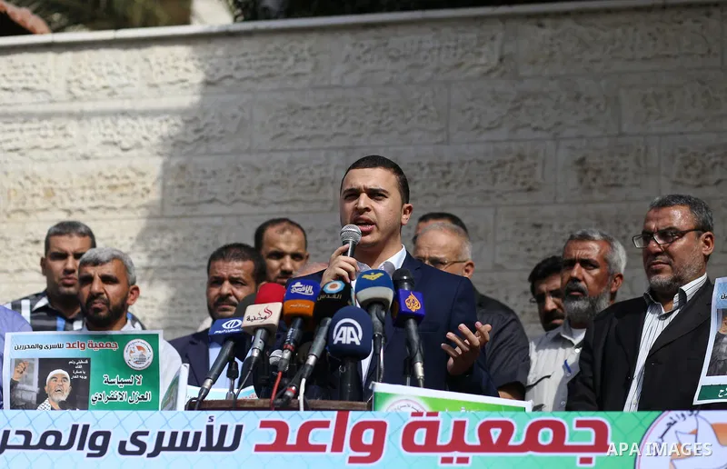 Palestinian members of Hamas legislative council and members of the factions hold banners during a protest to show solidarity with Leader of the northern Islamic Movement Sheikh Raed Salah who is in solitary confinement...