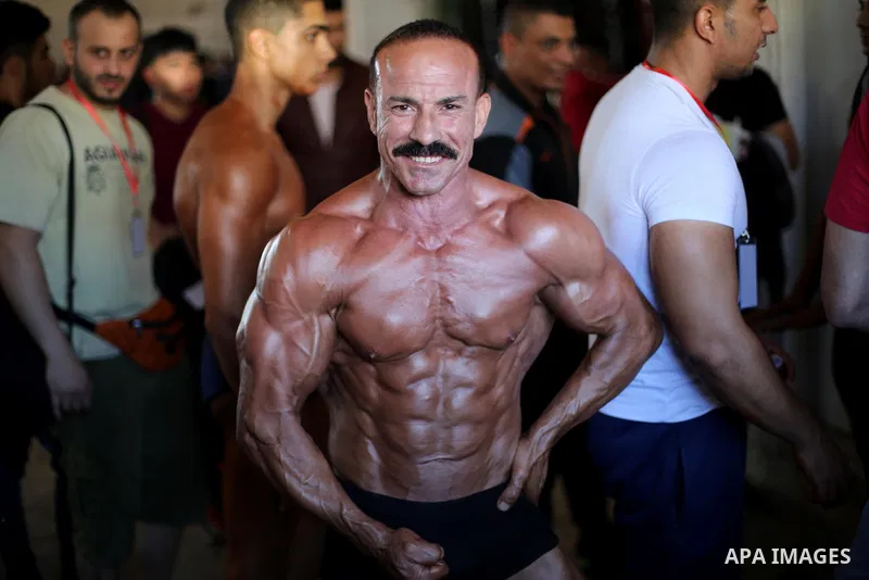 A Palestinian man competes in a local bodybuilding competition in Gaza city on October 28, 2016. Photo by Mohammed Asad