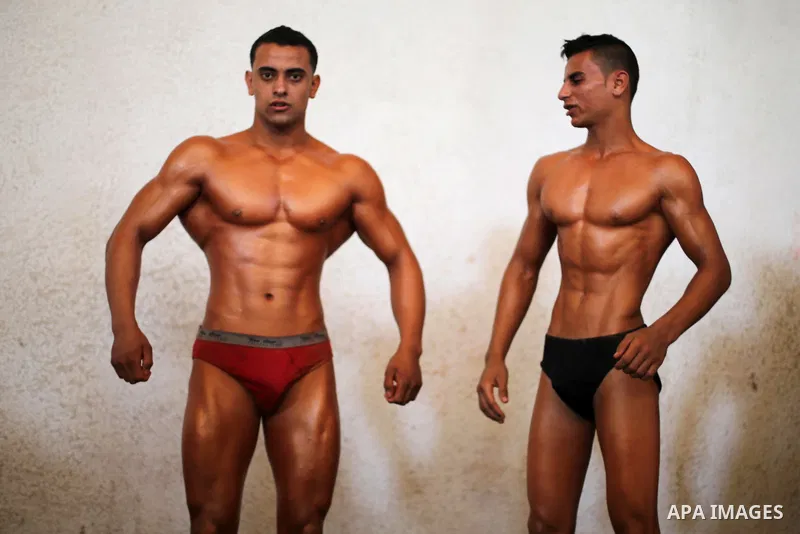 Palestinian men compete in a local bodybuilding competition in Gaza city on October 28, 2016. Photo by Mohammed Asad