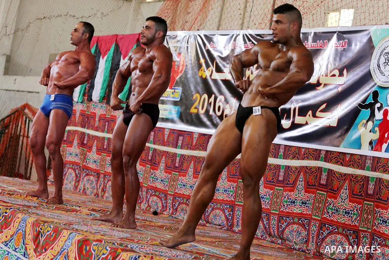 Palestinian men compete in a local bodybuilding competition in Gaza city on October 28, 2016. Photo by Mohammed Asad