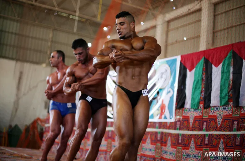 Palestinian men compete in a local bodybuilding competition in Gaza city on October 28, 2016. Photo by Mohammed Asad