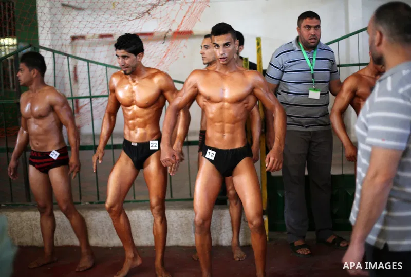 Palestinian men compete in a local bodybuilding competition in Gaza city on October 28, 2016. Photo by Mohammed Asad