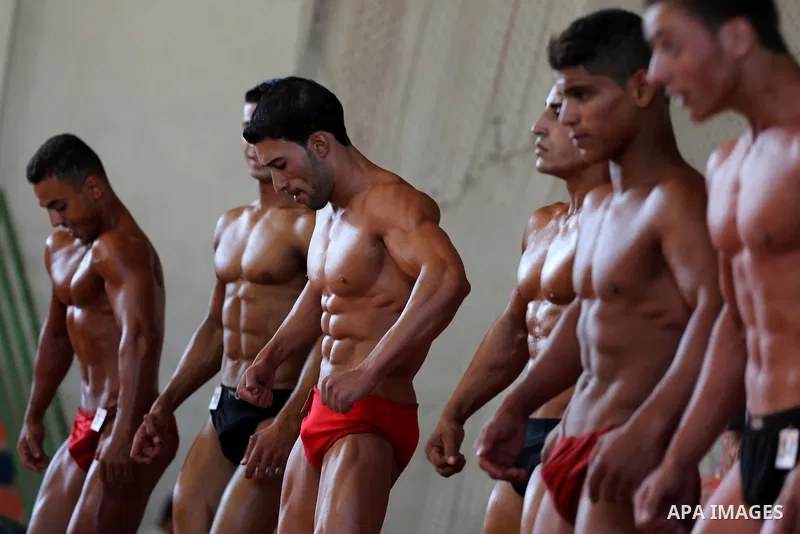 Palestinian men compete in a local bodybuilding competition in Gaza city on October 28, 2016. Photo by Mohammed Asad