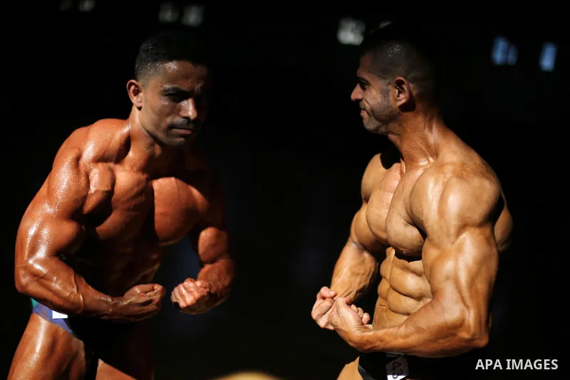 Palestinian men compete in a local bodybuilding competition in Gaza city on October 28, 2016. Photo by Mohammed Asad