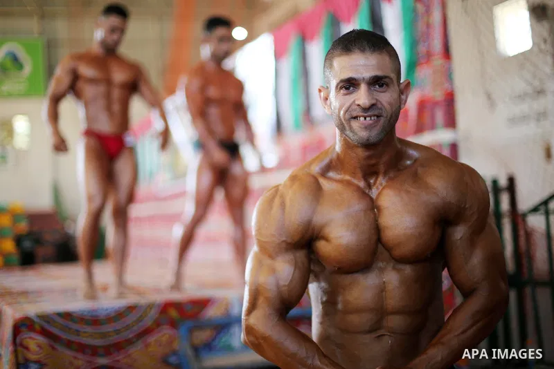 Palestinian men compete in a local bodybuilding competition in Gaza city on October 28, 2016. Photo by Mohammed Asad
