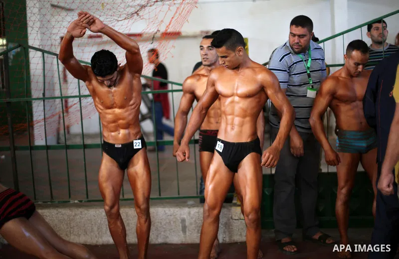Palestinian men compete in a local bodybuilding competition in Gaza city on October 28, 2016. Photo by Mohammed Asad