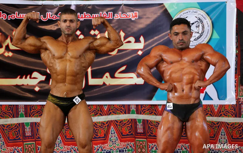 Palestinian men compete in a local bodybuilding competition in Gaza city on October 28, 2016. Photo by Mohammed Asad