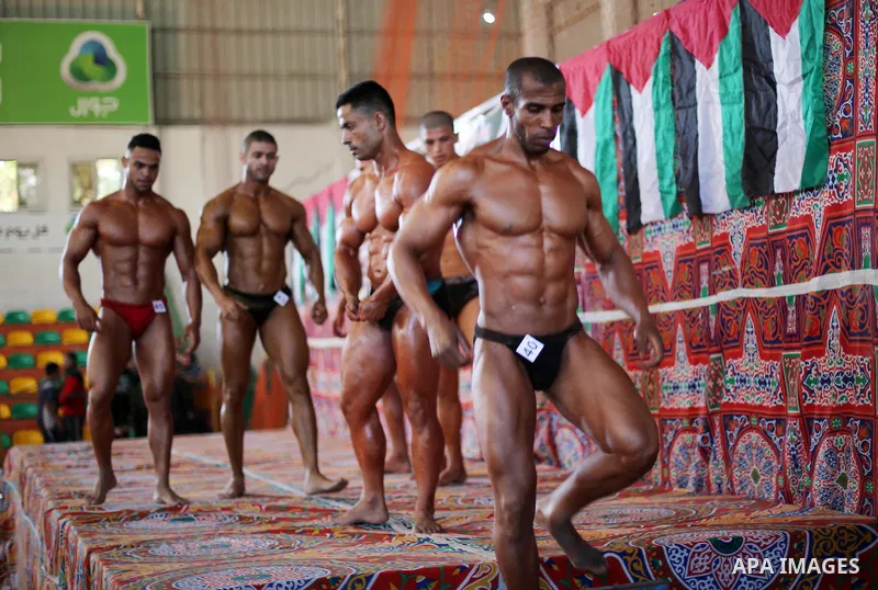 Palestinian men compete in a local bodybuilding competition in Gaza city on October 28, 2016. Photo by Mohammed Asad
