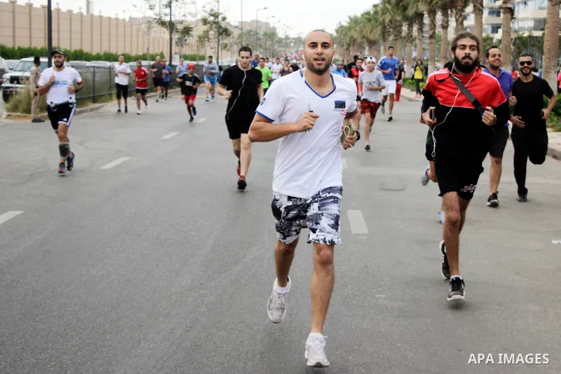 Egyptians run at street during a Marathon to raise awareness and funds to fight breast cancer, in Cairo, Egypt, on Oct. 28, 2016. Photo by Amr Sayed