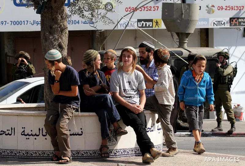 Israeli settlers take part in a protest against Palestinian stones throwers on October 28, 2016 on the main road of the village of Hawara in the northern West Bank. Photo by Nedal Eshtayah