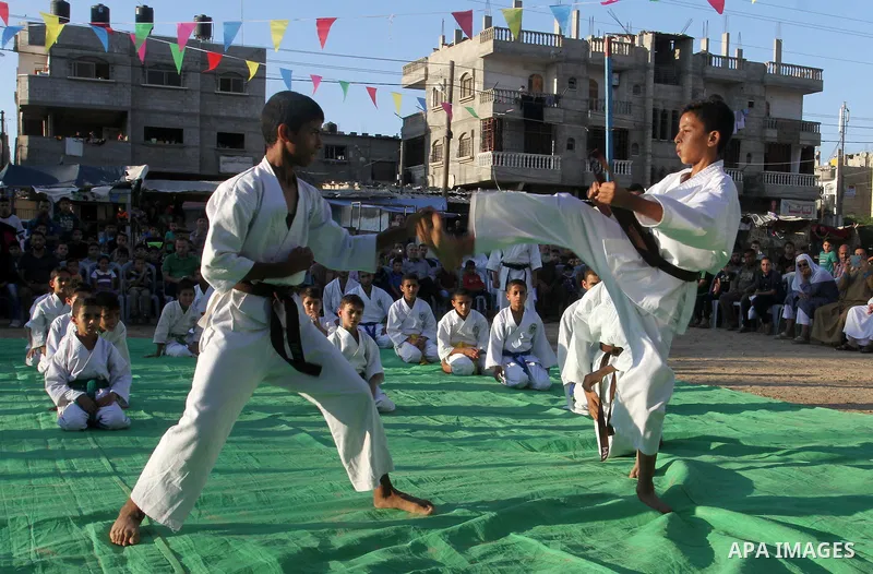 Palestinian children take part in a Karate graduation session at a club in Rafah, in the southern Gaza strip, on Oct. 28, 2016. Photo by Abed Rahim Khatib