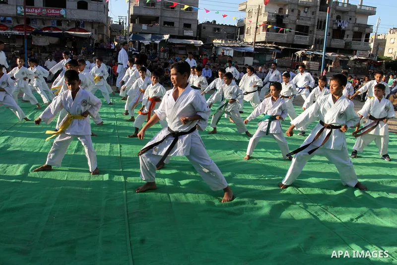 Palestinian children take part in a Karate graduation session at a club in Rafah, in the southern Gaza strip, on Oct. 28, 2016. Photo by Abed Rahim Khatib