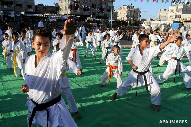 Palestinian children take part in a Karate graduation session at a club in Rafah, in the southern Gaza strip, on Oct. 28, 2016. Photo by Abed Rahim Khatib