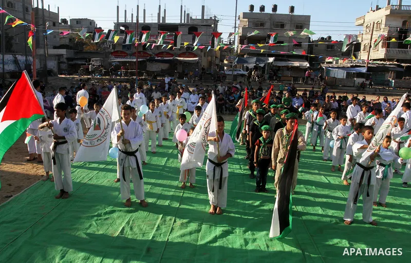 Palestinian children take part in a Karate graduation session at a club in Rafah, in the southern Gaza strip, on Oct. 28, 2016. Photo by Abed Rahim Khatib