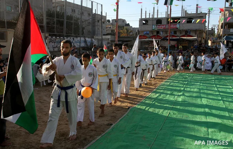 Palestinian children take part in a Karate graduation session at a club in Rafah, in the southern Gaza strip, on Oct. 28, 2016. Photo by Abed Rahim Khatib