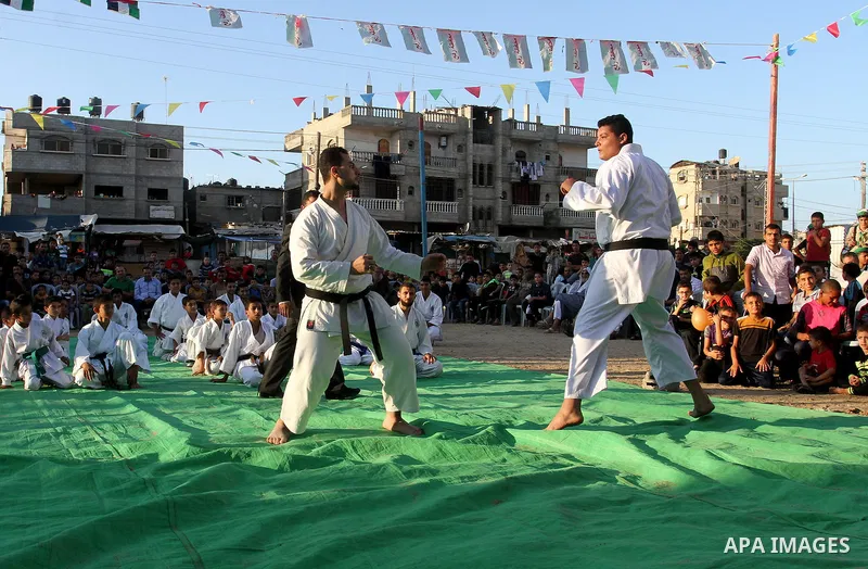 Palestinian children take part in a Karate graduation session at a club in Rafah, in the southern Gaza strip, on Oct. 28, 2016. Photo by Abed Rahim Khatib