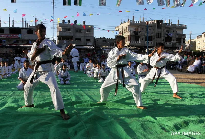 Palestinian children take part in a Karate graduation session at a club in Rafah, in the southern Gaza strip, on Oct. 28, 2016. Photo by Abed Rahim Khatib
