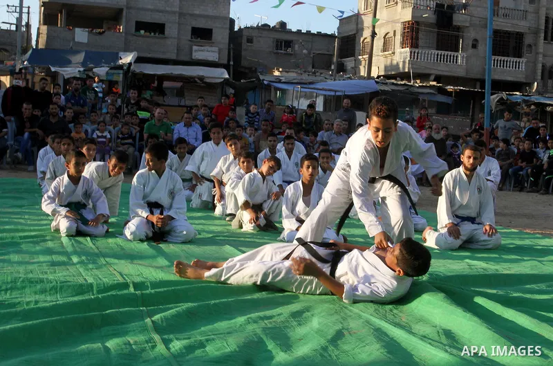 Palestinian children take part in a Karate graduation session at a club in Rafah, in the southern Gaza strip, on Oct. 28, 2016. Photo by Abed Rahim Khatib