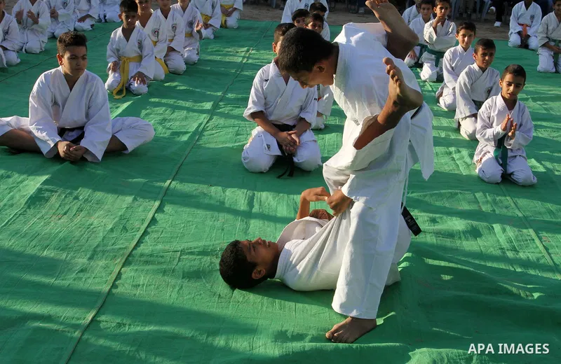 Palestinian children take part in a Karate graduation session at a club in Rafah, in the southern Gaza strip, on Oct. 28, 2016. Photo by Abed Rahim Khatib